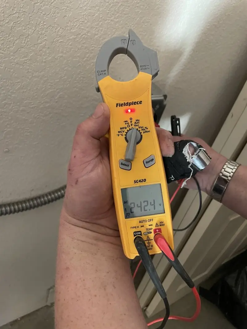 Voltage testing with clamp meter during Ceiling Fan Installation in Arnold